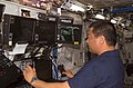 Leroy Chiao works with the controls of the Canadarm2, or Space Station Remote Manipulator System (SSRMS)